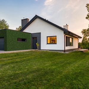 Stylish house with large lawn and garage, outdoors